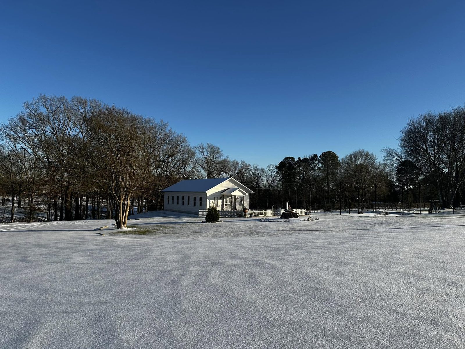 The white chapel on a bright winter morning with snow across the field